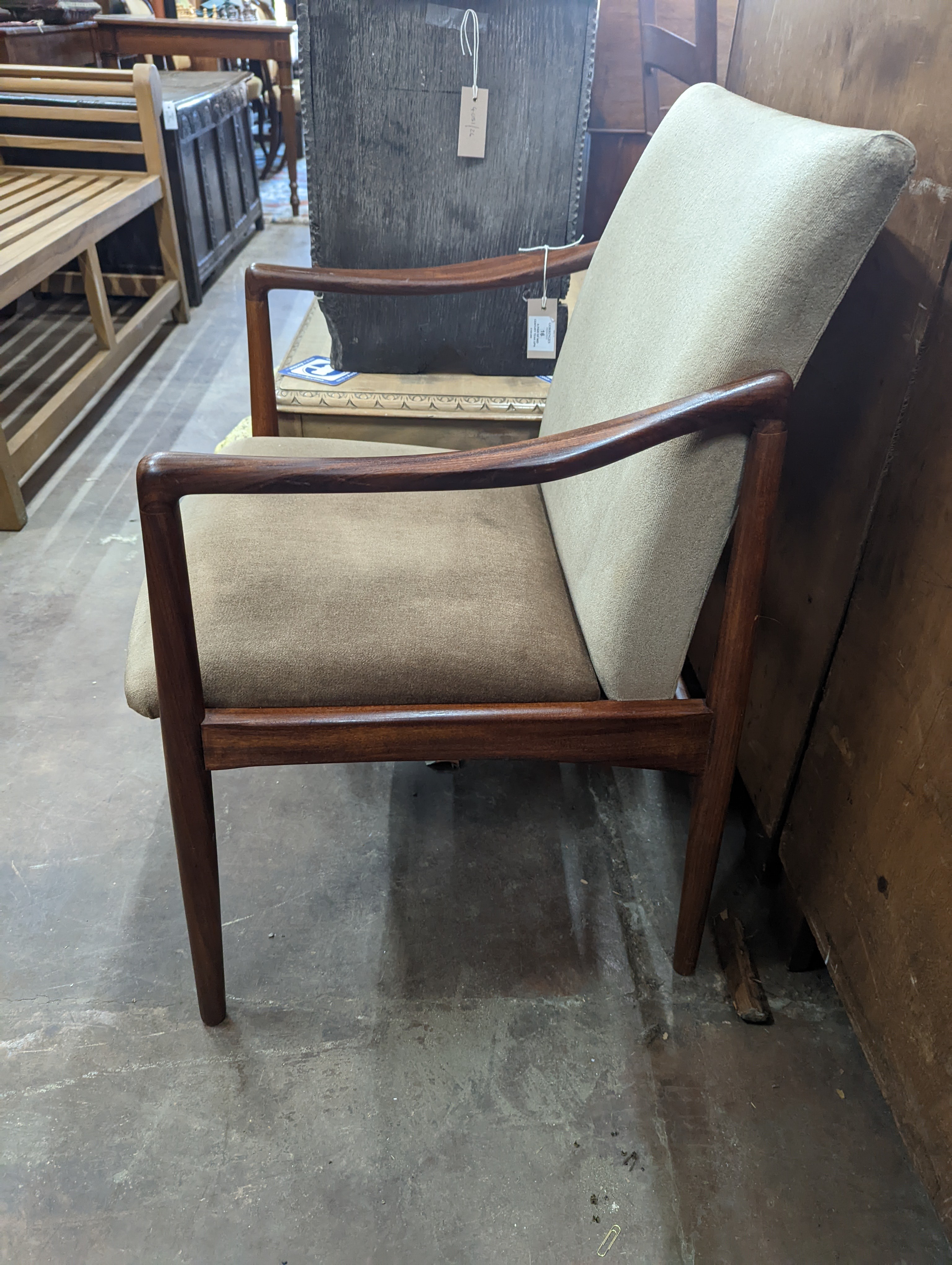 A pair of mid century teak upholstered elbow chairs, width 54cm, depth 63cm, height 84cm